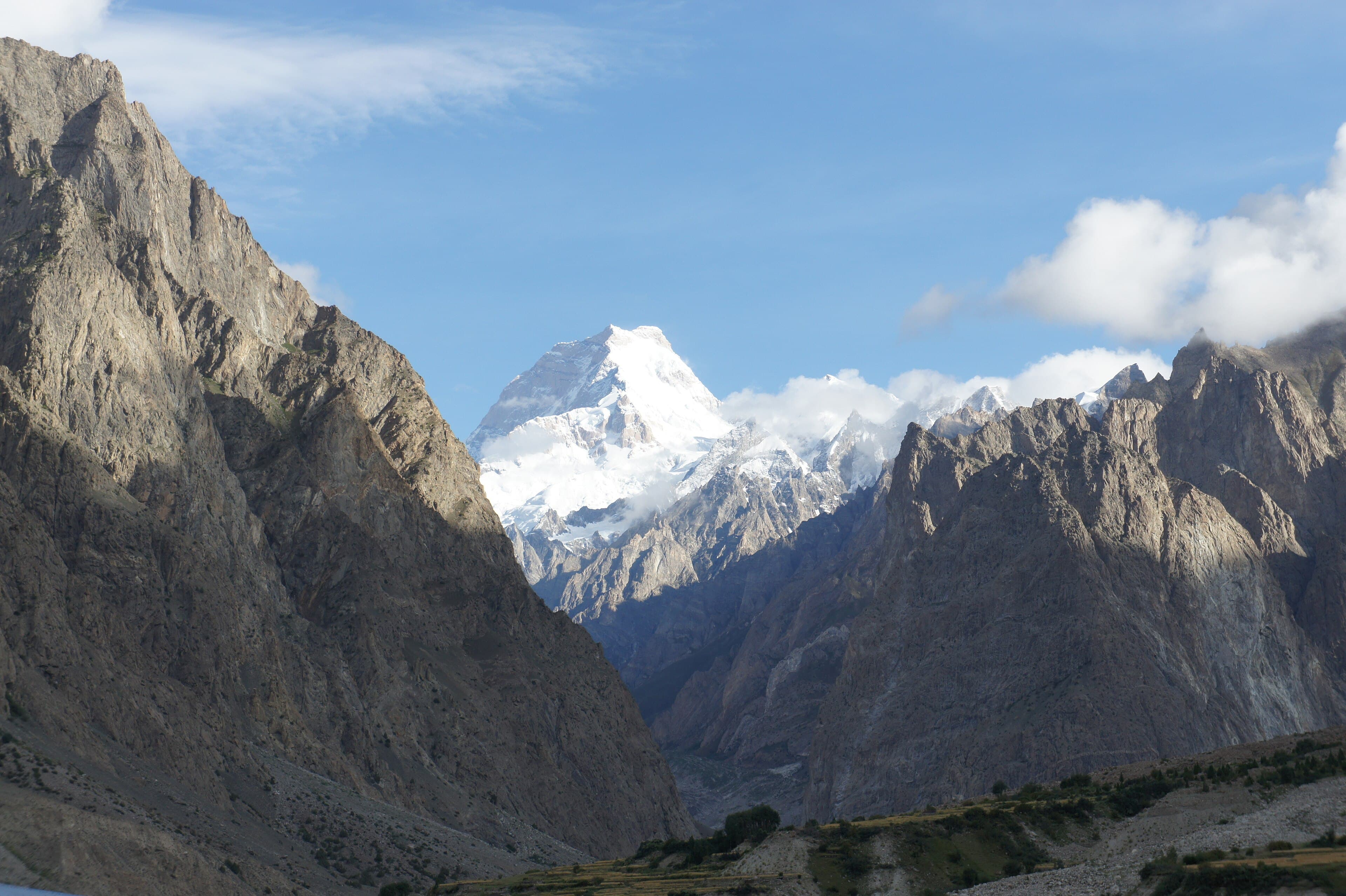 Hushe village and its fields below the snow pyramid of Masherbrum