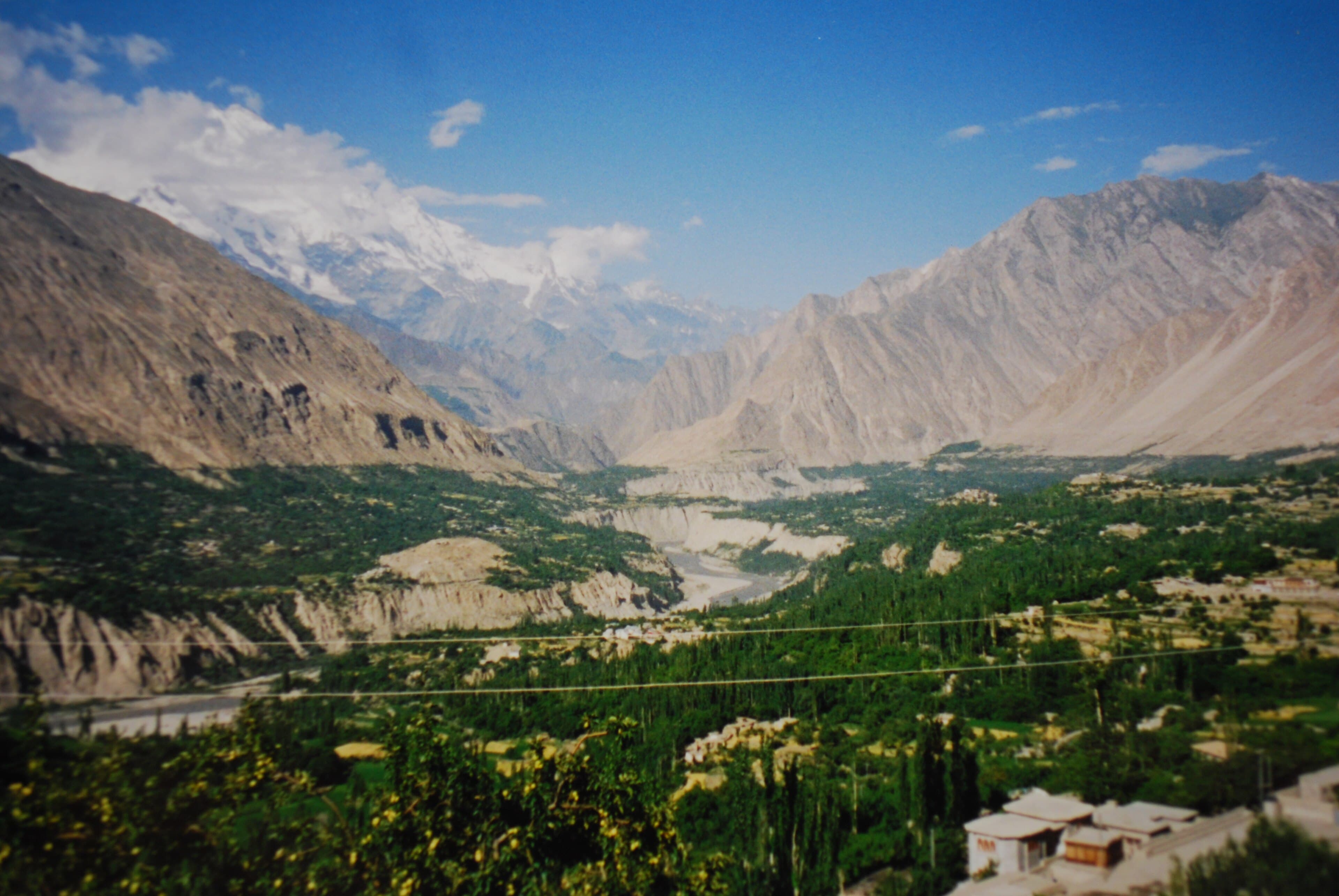 Karimabad town and bazaar below Baltit Fort with Hunza peaks behind