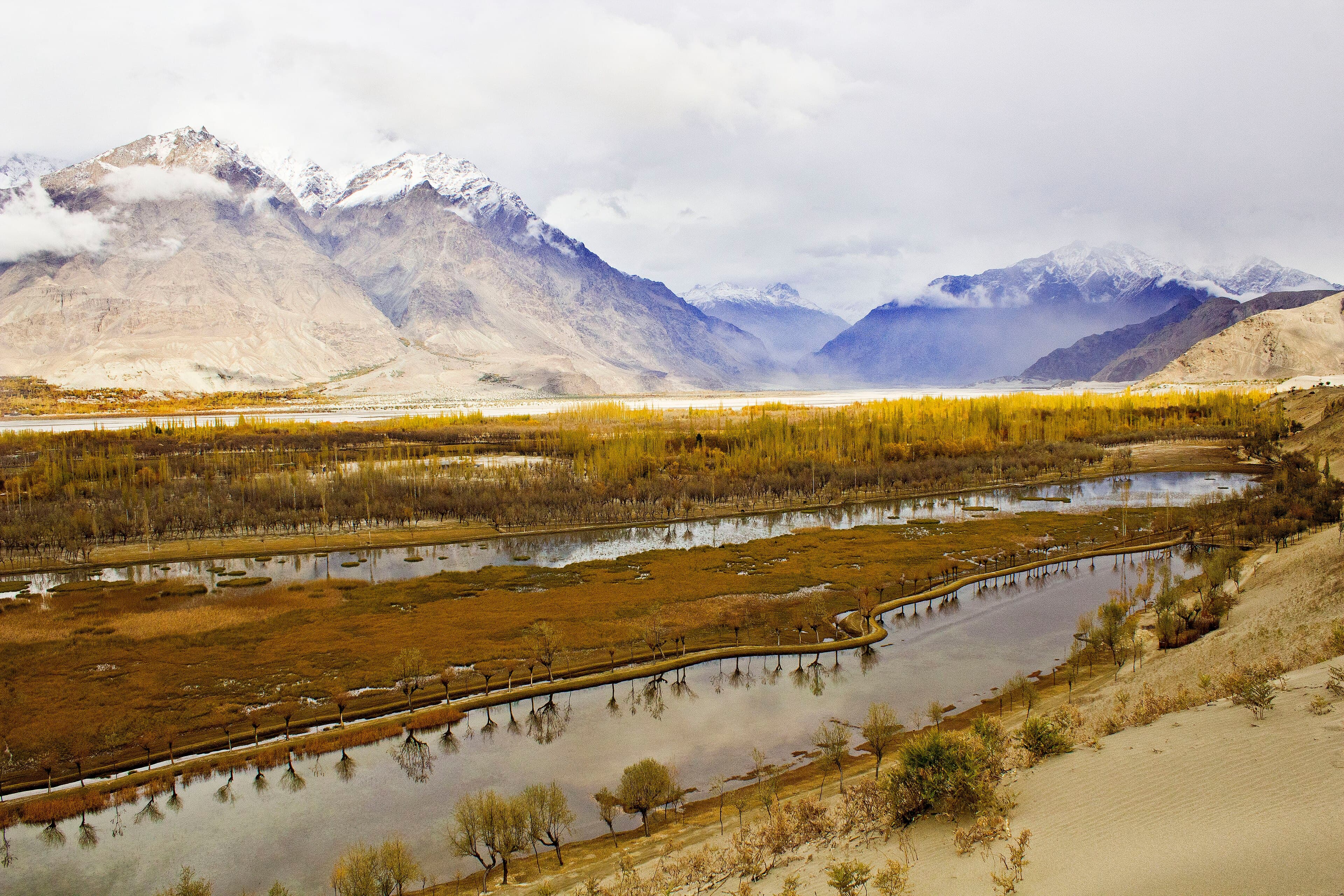 Katpana cold desert dunes near Skardu with light snow and mountains