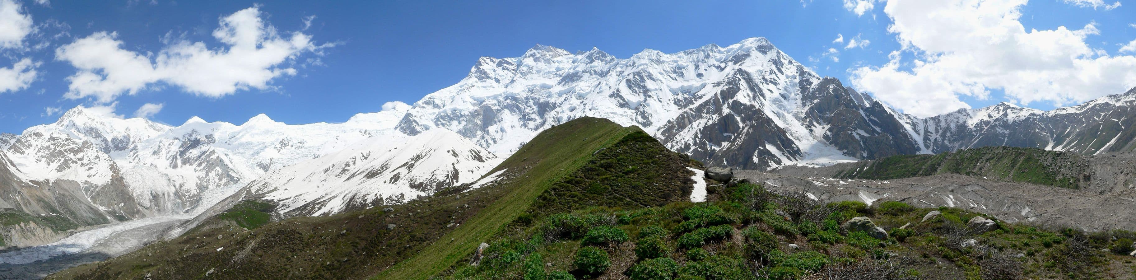 Trekkers approaching Nanga Parbat Base Camp above the Raikot Glacier