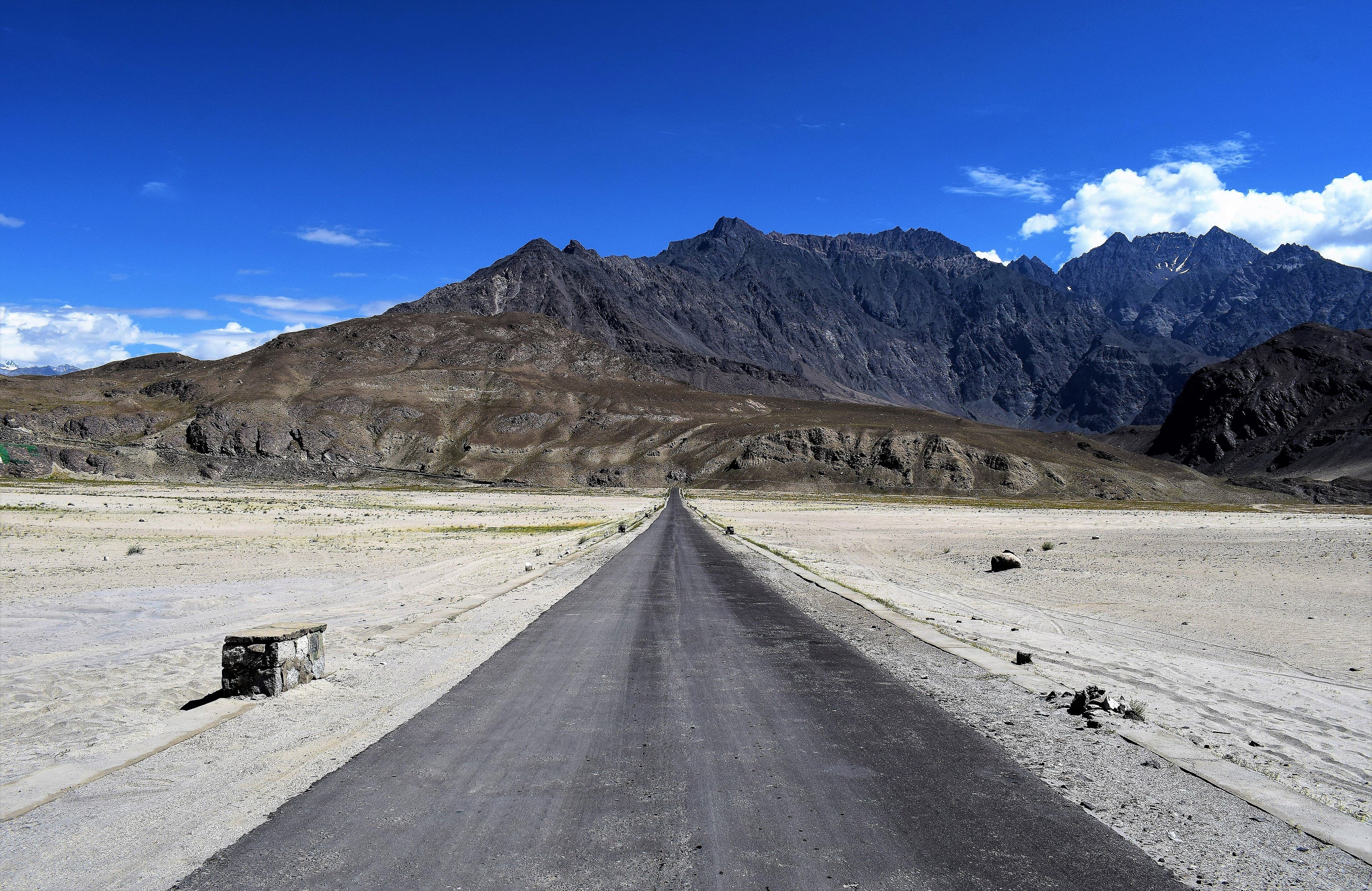 Sand dunes of the Sarfaranga cold desert with Karakoram mountains behind