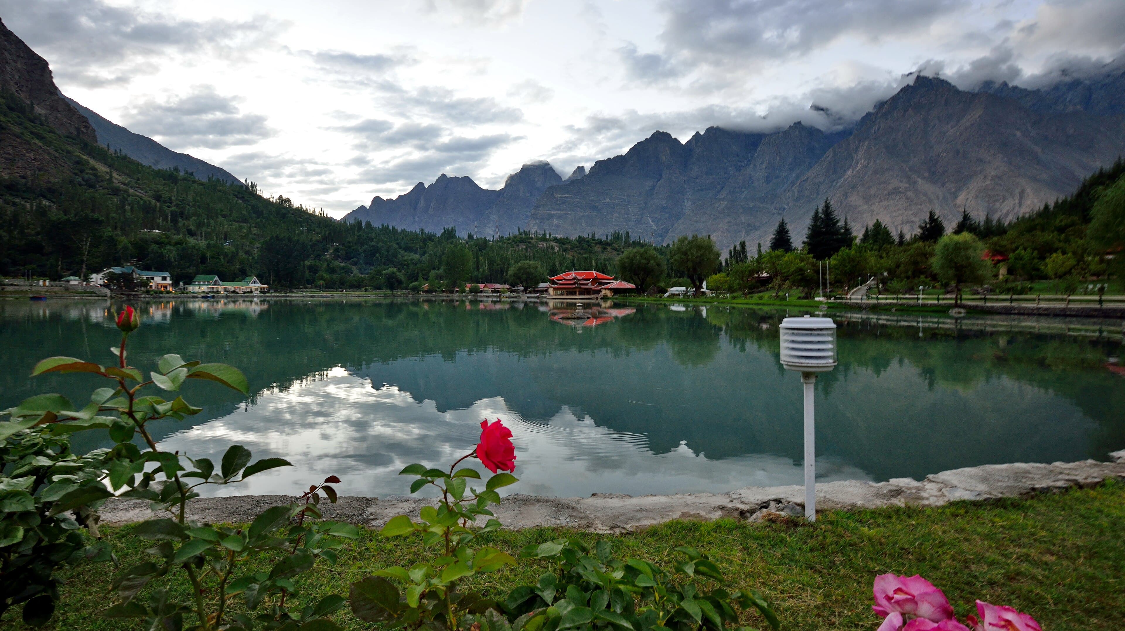 Red-roofed cottages of Shangrila Resort reflected in Lower Kachura Lake